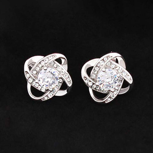 Love Knot stud earrings in 14k white gold finish with cubic zirconia center stone