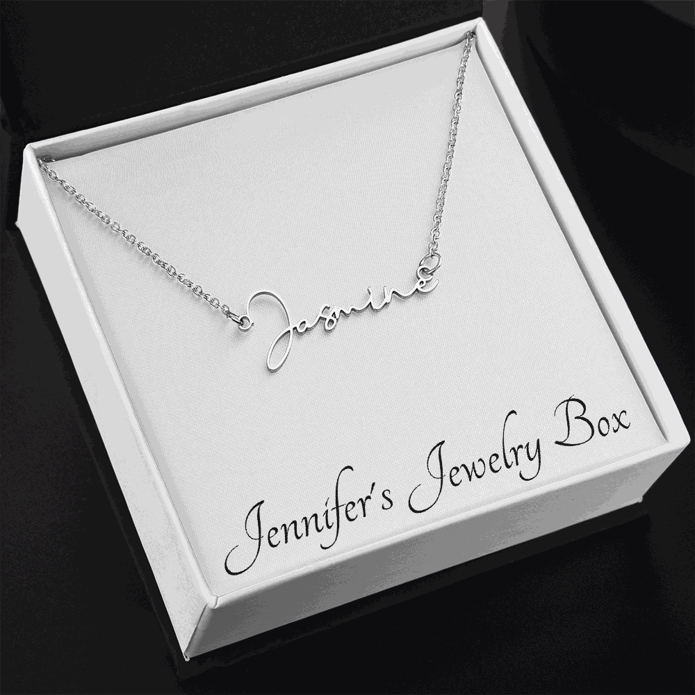 Signature Style Name Necklace in polished stainless steel on adjustable cable chain, displayed on a woman's neck